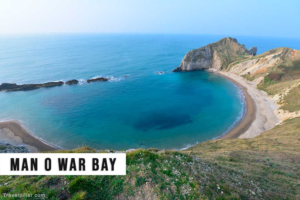 Man O War Bay with the stone arch of Durdle Door just visible in the background